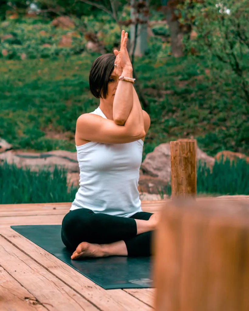Woman practicing yoga on deck